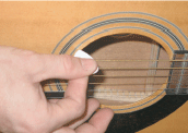 Playing guitar with a pick